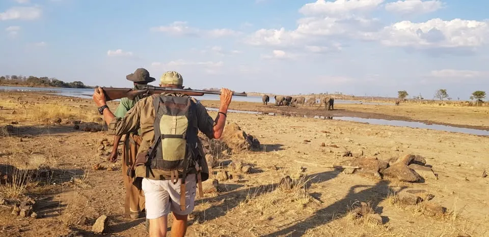Leon Varley's trackers walking the dry riverbed near Victoria Falls