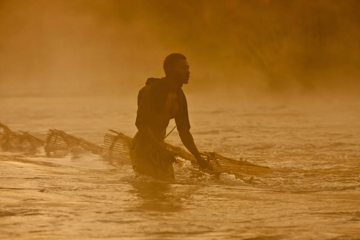 A fisherman on the Zambezi in golden light