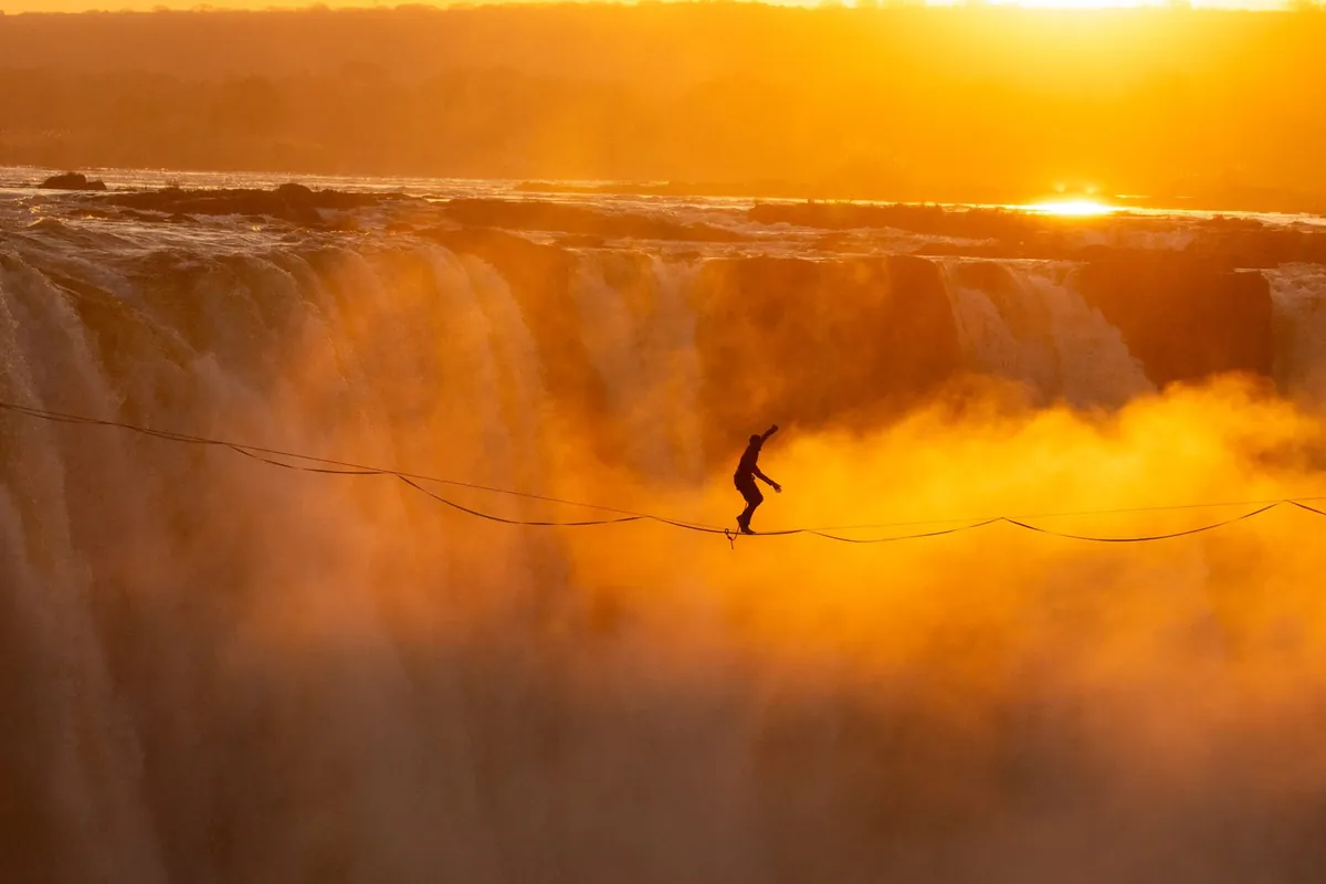 A slackliner above the gorge at sunset